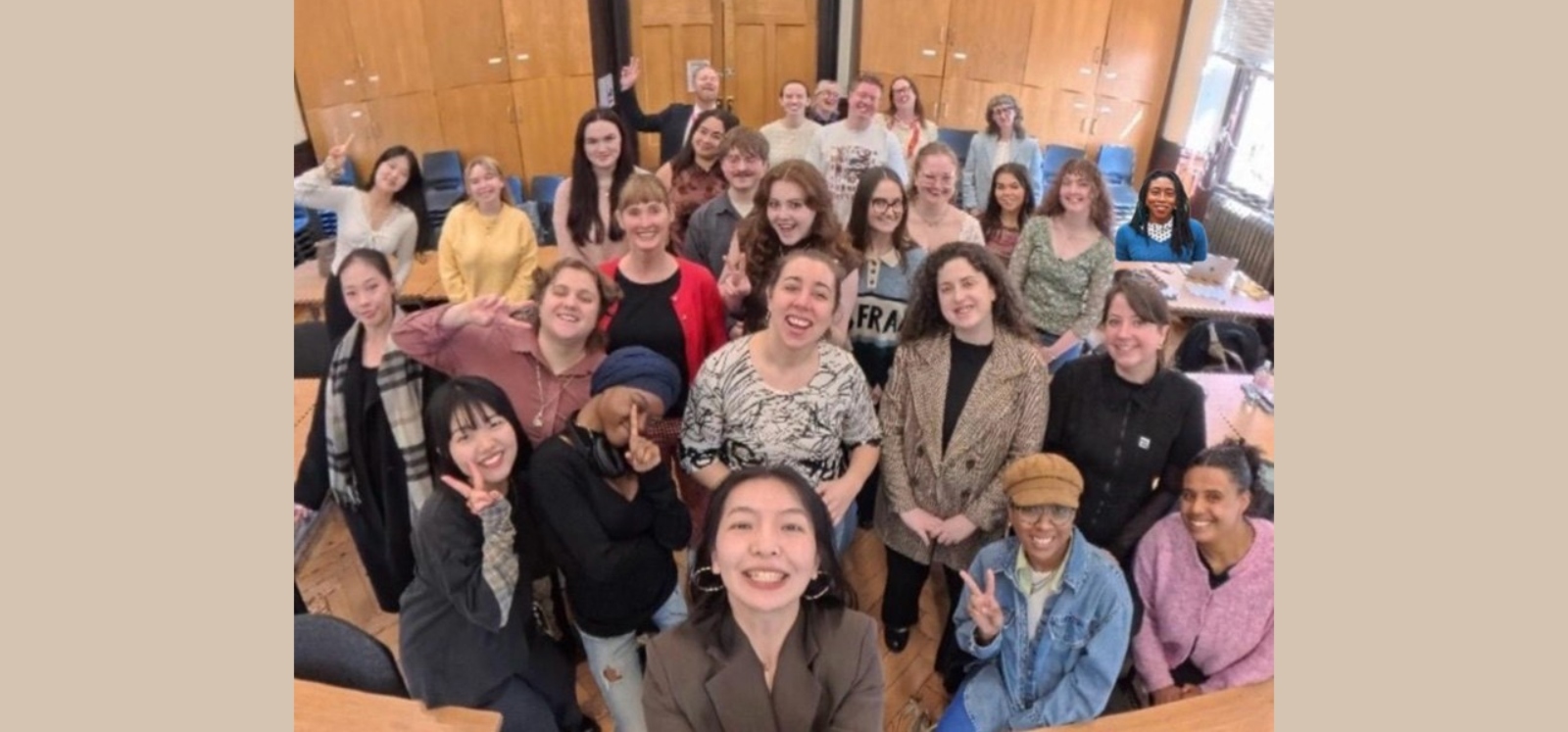 A group of people smiling for a group photo/selfie